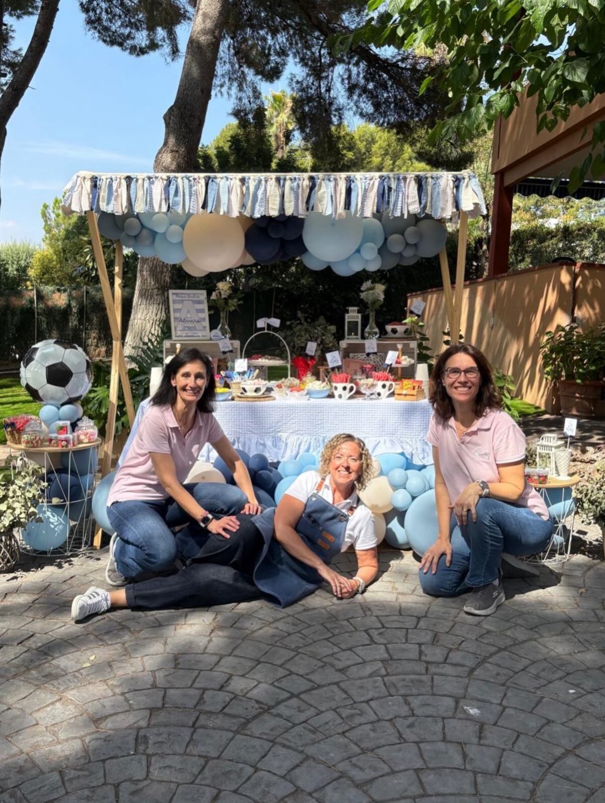 Equipo junto al montaje de comunión de Álvaro con globos azules